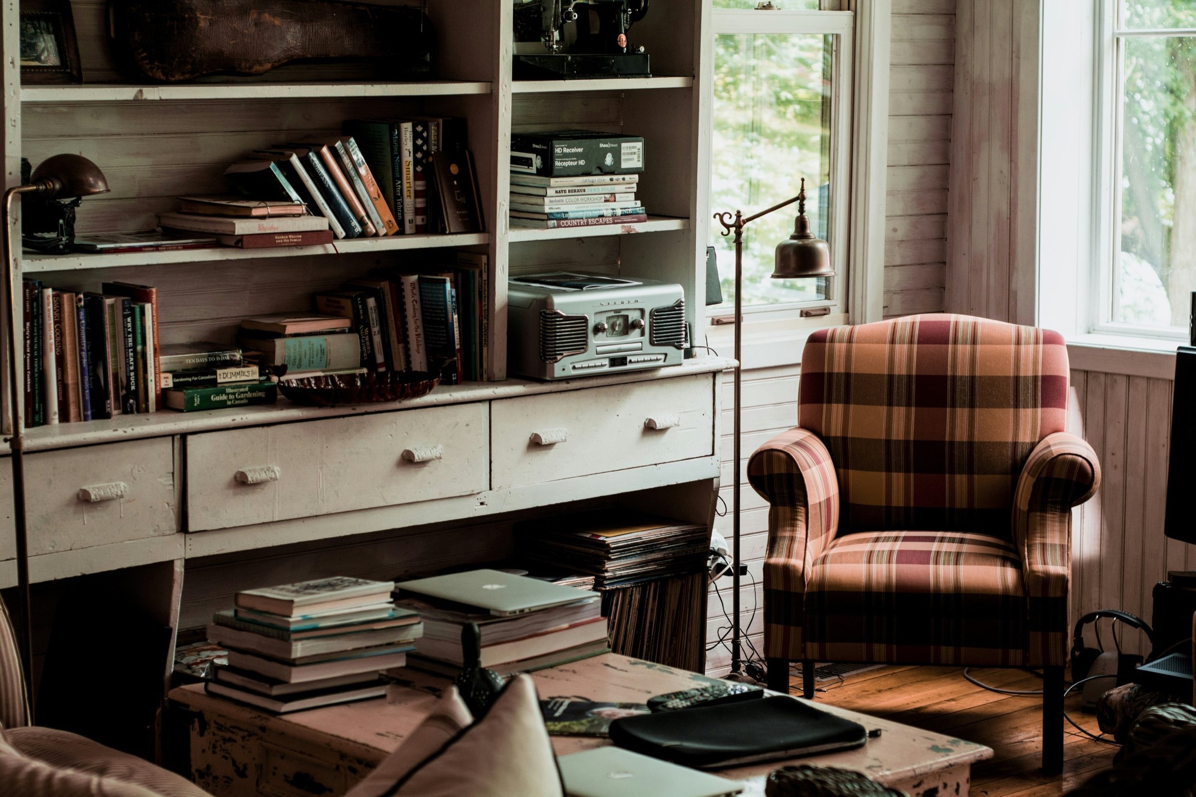 A clinician's study: books, a lamp and an armchair by the window